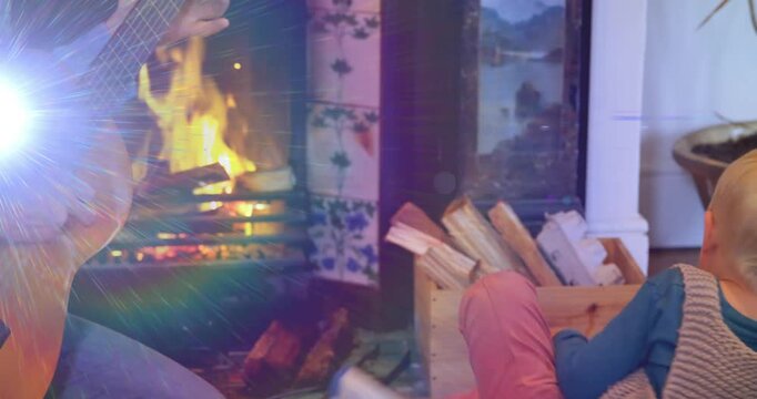 Animation of light flashing over caucasian father playing guitar and singing to son