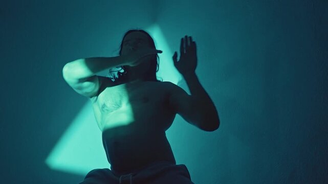 Shirtless Martial Artist Executing Precise Defensive Blocks Under Teal Triangle Light, Strong Silhouette, Sharp Forearm Alignment, Clinical Studio Training With Tense Dramatic Mood