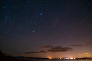Fototapeta premium Starry Night Sky Over Coastal Landscape