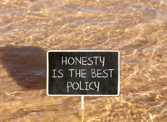 Naklejka premium Honesty is the best policy symbol. Concept words Honesty is the best policy on beautiful blackboard. Beautiful Red sea water background. Business honesty is the best policy concept. Copy space.