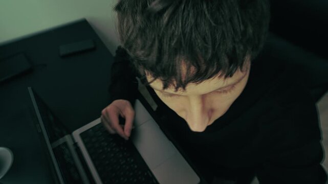 Mental health anxiety and disorientation, man experiencing dizziness and confusion while working at computer. Sensory overload and psychological stress caused by intense work and screen exposure.