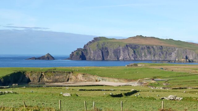 Rural farmland and Clogher Strand in Graigue, County Kerry on the Dingle Peninsula, from Slea Head Drive on the far west Atlantic coast of the Republic of Ireland.