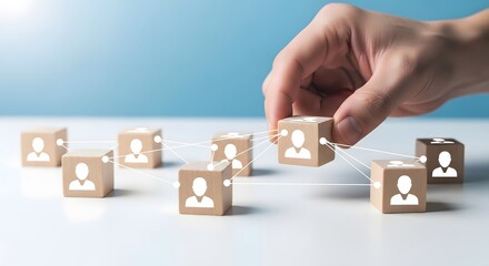 Hand selecting a wooden block with a person icon from a connected network