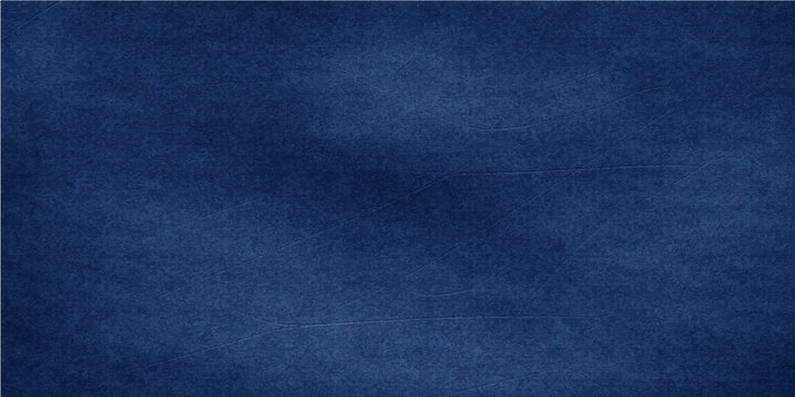 A closeup of a dark blue jeans denim fabric texture shows a rough cotton textile material pattern with a textured surface suitable for a fashion clothing background or wallpaper backdrop