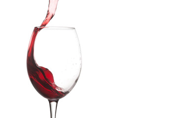 Close-up red wine glass pouring splash flow.  Macro view splashing red wine, falling action on white background. copy space