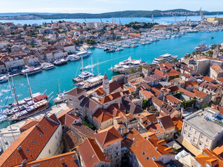 Wide drone panorama of Trogir old town, marina, luxury yachts and turquoise Adriatic water on a bright summer day in Croatia