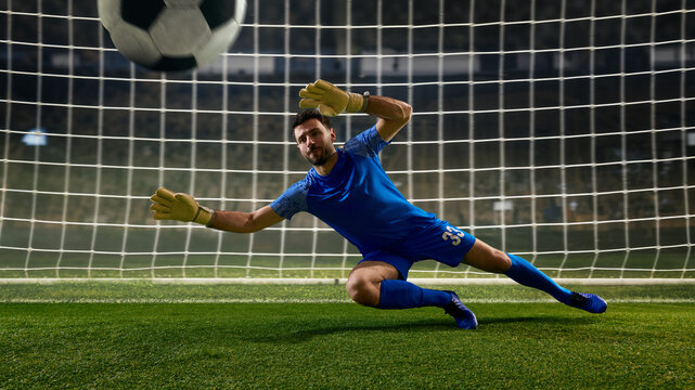 Soccer goalkeeper stopping close range shot during match play. Concept of one on one situation, scoring chance prevention, football analysis, coaching materials, sports advertising, and match coverage