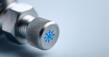 Close-up of metal valve with snowflake symbol