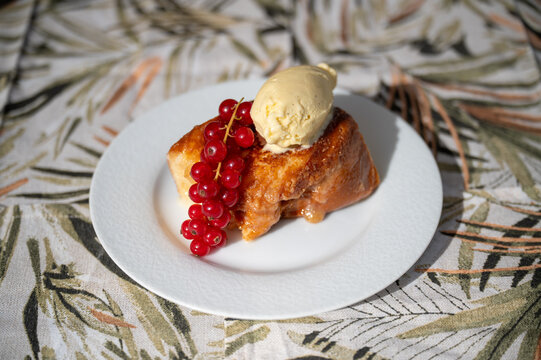 Traditional spanish dessert, torrija with ice cream and berry.