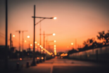 Blurred Sunset Street View with Orange Sky and Streetlights Creating Star Shaped Bokeh in Urban Environment