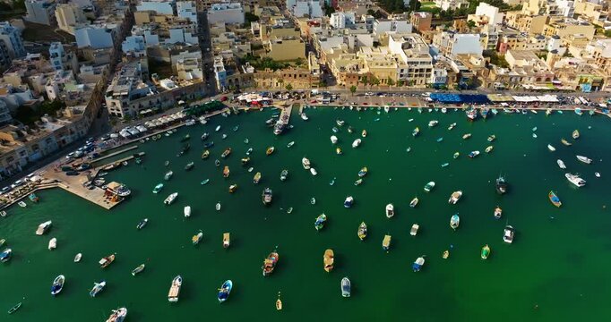 Aerial view of the Port of Marsaxlokk In Malta. A small fishing village with traditional colorful boats