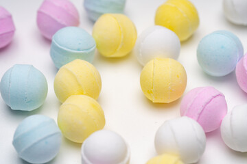 Colorful ramune candy scattered on white background