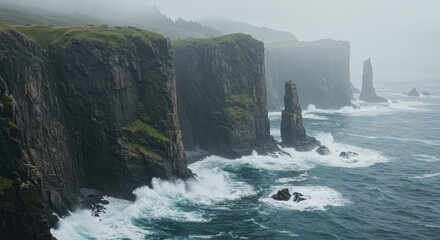 Dramatic coastal cliffs in misty atmosphere with ocean waves and formations