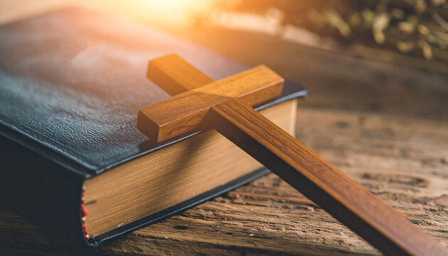 Handcrafted wooden cross on vintage Bible, wooden table, spirituality, Christian faith, cultural artifact.