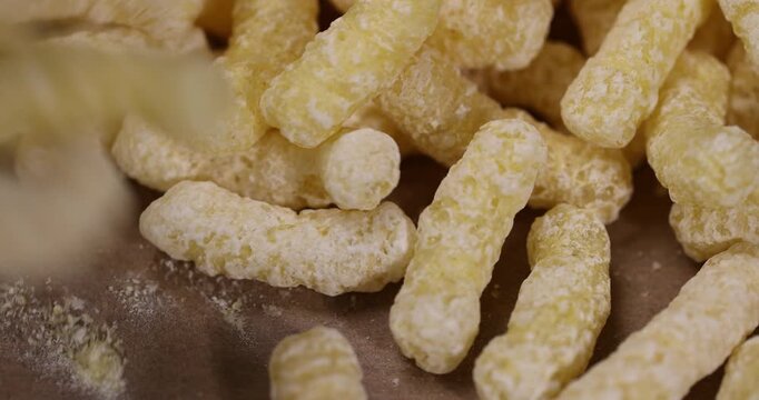 yellow large sweet sticks of corn flour with added sugar for quick cooking with yogurt, ready-to-eat corn sticks scattered on food paper