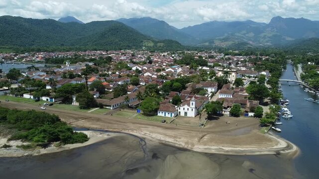 panning drone view of Paraty, with the mountains and the Atlantic forest that surrounds this Idyllic city