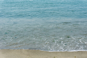 Sand and sea with waves on the beach