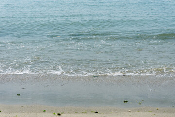 Sand and sea with waves on the beach