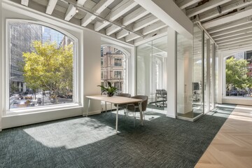 Modern office space with large arched windows, a table, chairs, and city views