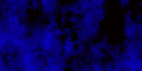 
Artificial magic smoke in black and blue light on black background in darkness. light blue and dark blue background. Black and blue Grunge Concrete Wall Texture Background.

