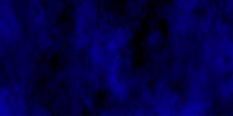 
Artificial magic smoke in black and blue light on black background in darkness. light blue and dark blue background. Black and blue Grunge Concrete Wall Texture Background.

