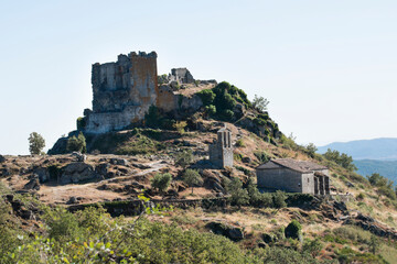 Fototapeta premium Trevejo Castle. Panoramic view of the ancient castle of Trevejo, where part of its tower and some tombs carved into the rock can still be seen. A beautiful town in the Sierra de Gata mountains of Extr