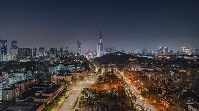 Panoramic night view of Nanjing, China, featuring Zifeng Tower and Jiming Temple in the same frame