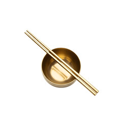 Gold plate with two chopsticks in the middle and white chopstick in.