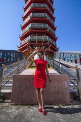 Young Woman Celebrating New Year at Colorful Asian Pagoda