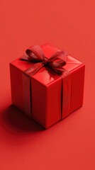 Obraz premium Square Red Gift Box with Ribbon Bow on Matching Background in Soft Lighting for Holiday Theme Product Shot
