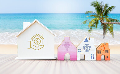 Miniature house with logo over tropical beach, property investment business concept