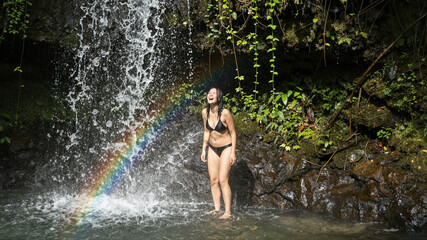 Fototapeta premium Woman Splashing In Waterfall Basin