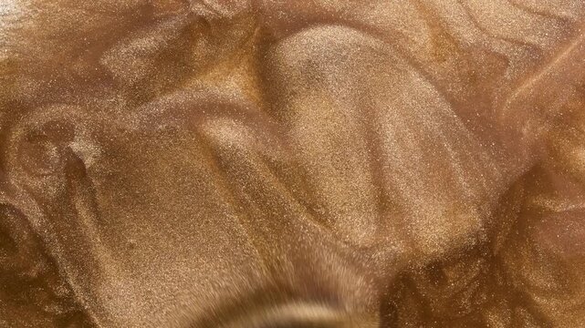 Golden smears of liquid texture with small spatula. Gold metallic paint, Lip Gloss or nail polish, make-up