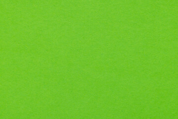 Top view of bright green paper texture background,A high-resolution, close-up shot of vibrant lime green construction paper texture. This uniform and grainy surface is perfect for use as a minimalist 