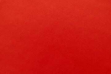 Fototapeta premium Red Paper Texture Background,High-resolution close-up of a vibrant red paper texture with a subtle grainy surface, ideal for holiday backgrounds, Christmas cards, or creative design projects.