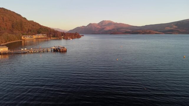 Aerial sunset view of Loch Lomond and Luss Pier in Sctland