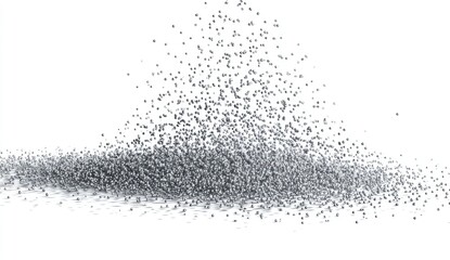 Tiny particles cascade down onto a surface, creating a pile with a bright background