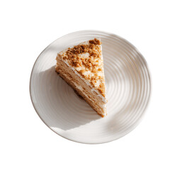 Overhead view of a delicious layered cake slice with cream frosting and crumbs on a white plate