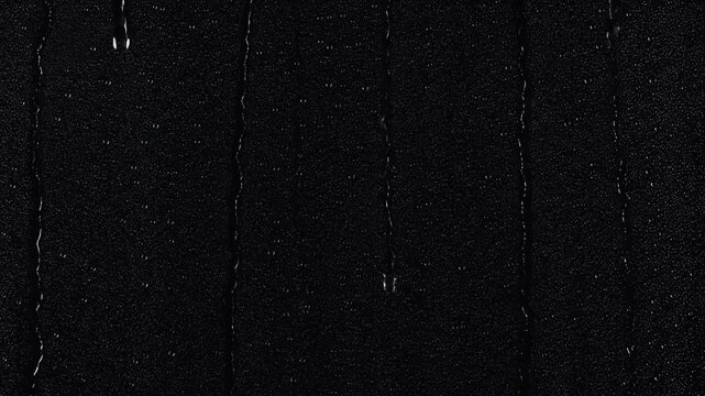Raindrops falling on glass with black screen effect overlay