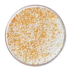 Overhead shot round dish filled with tiny, sparkling white and gold confectionery sprinkles
