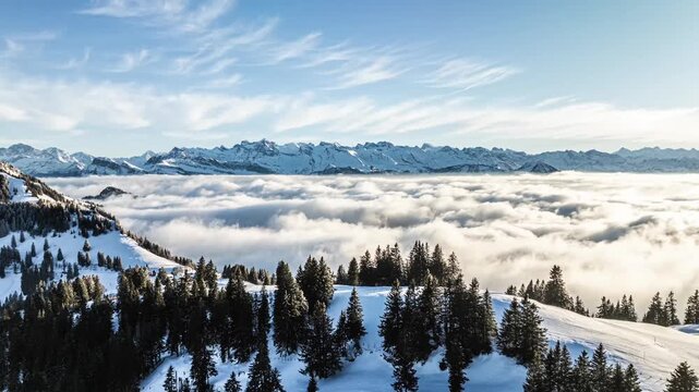 Wide aerial panorama of snowy alpine mountains and coud inversion