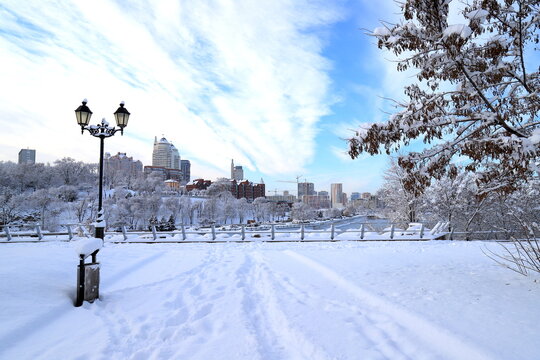 Winter city landscape, covered with snow with a beautiful lantern. The best scenic view of the winter street, big buildings, skyscrapers,