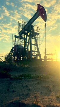 Fossil fuels. Crude pump jack on sunrise in oil field. Oil Pump Jack Operates on Beautiful Sunset at Oil Field in Industrial Area. Oil drill rig, drilling derrick in oilfield. Crude petroleum industry