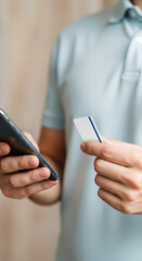 Man Holding Smartphone and Credit Card