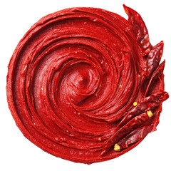 Swirled red paste with dried chili peppers, top view