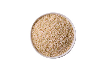 White sesame seeds in a bowl, an ingredient for oil and healthy eating. White sesame