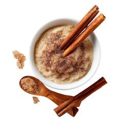 Overhead Bowl of cinnamon-sugar, aromatic sticks, wooden spoon, crumbs on dark background