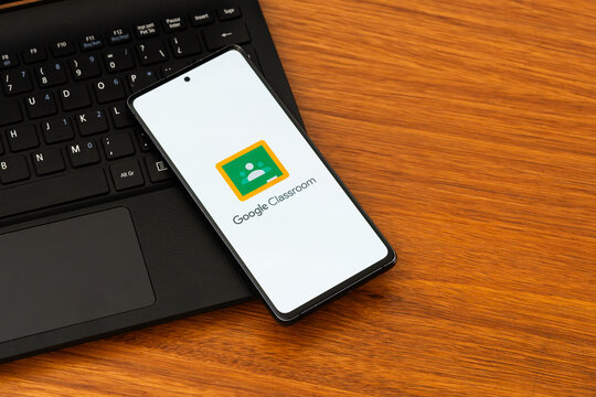 Punta Arenas, Chile &ndash; February 04, 2026: Iconic green and yellow Google Classroom "chalkboard" logo displayed on a mobile phone screen resting on a laptop