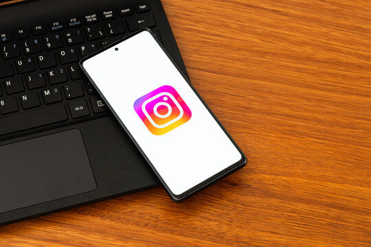 Punta Arenas, Chile &ndash; February 04, 2026: Iconic vibrant gradient Instagram "camera" logo on a mobile phone screen resting on a laptop