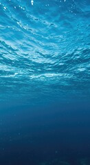 Obraz premium Dynamic blue ocean water full of healthy life and vigorous movement, showcasing a thriving, vibrant aquatic ecosystem deep underwater ,submarine ,thriving ,ecology